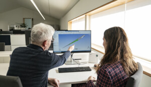 2 people looking at a computer screen.